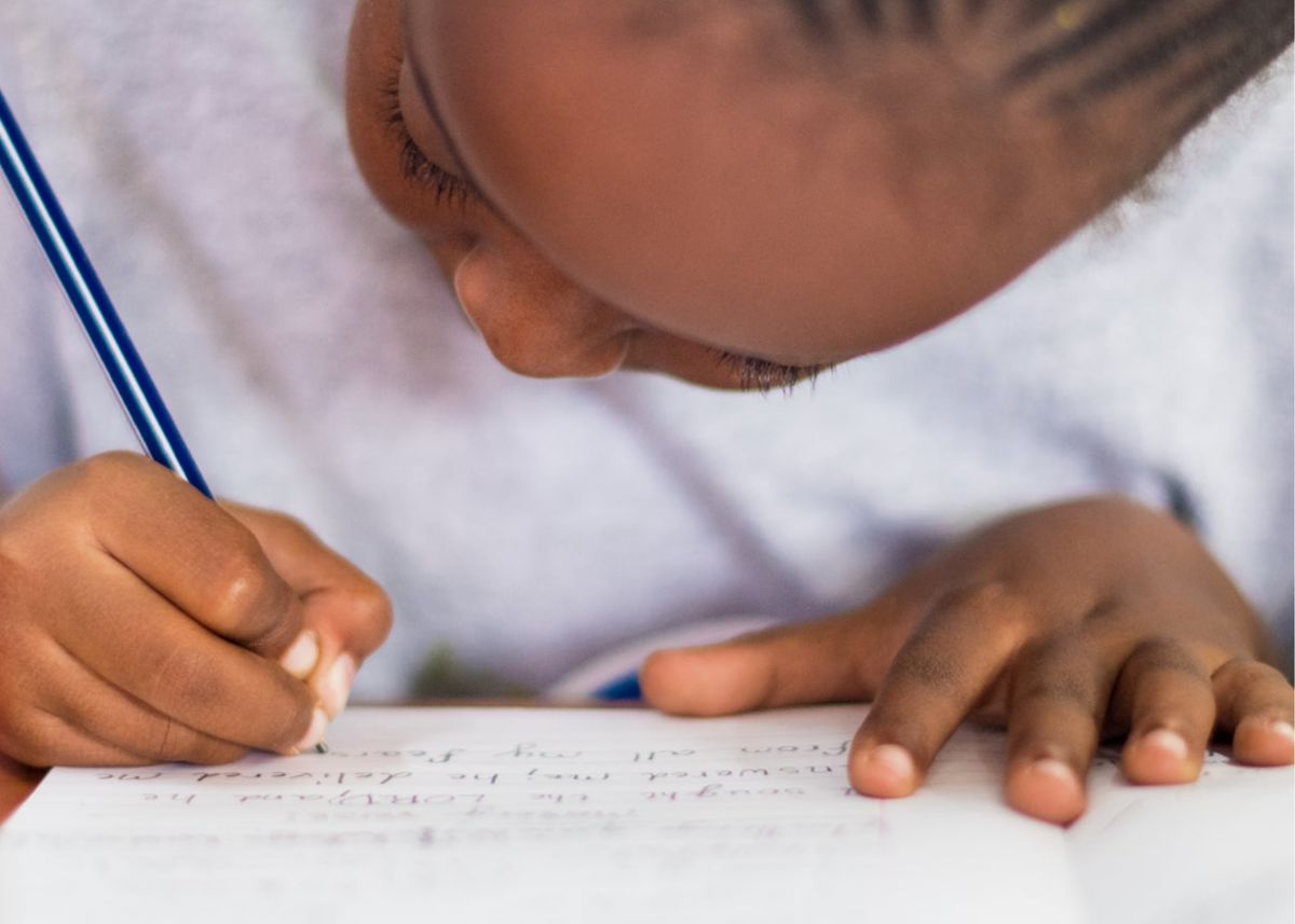 Close view of a child concentrating while writing