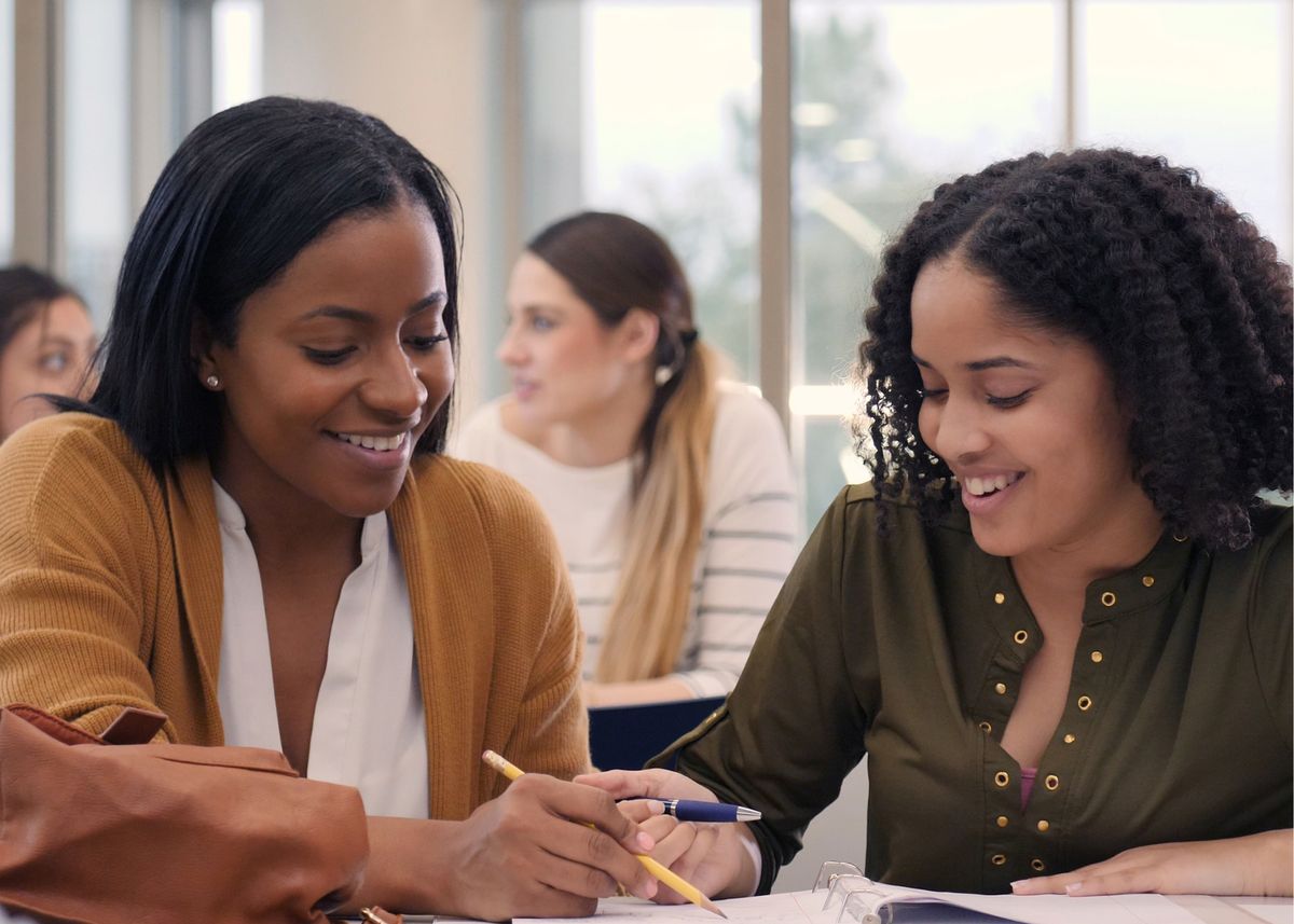Two students working together at a table
